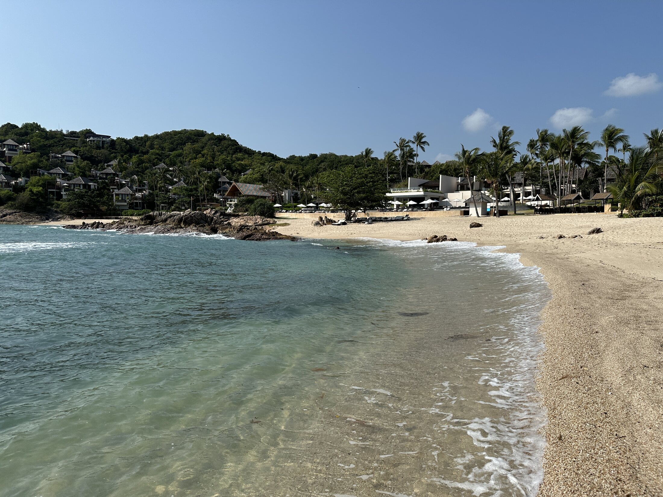 Clear shallow water and sandy beach at The Ritz-Carlton Koh Samui