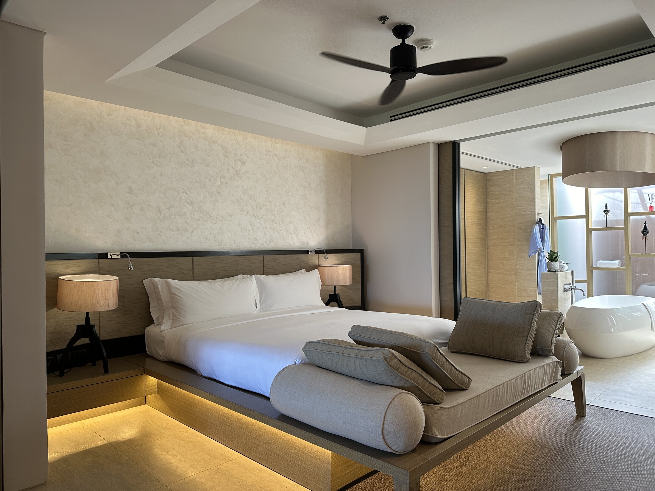 Essential Suite bed and bathroom at The Ritz-Carlton Koh Samui