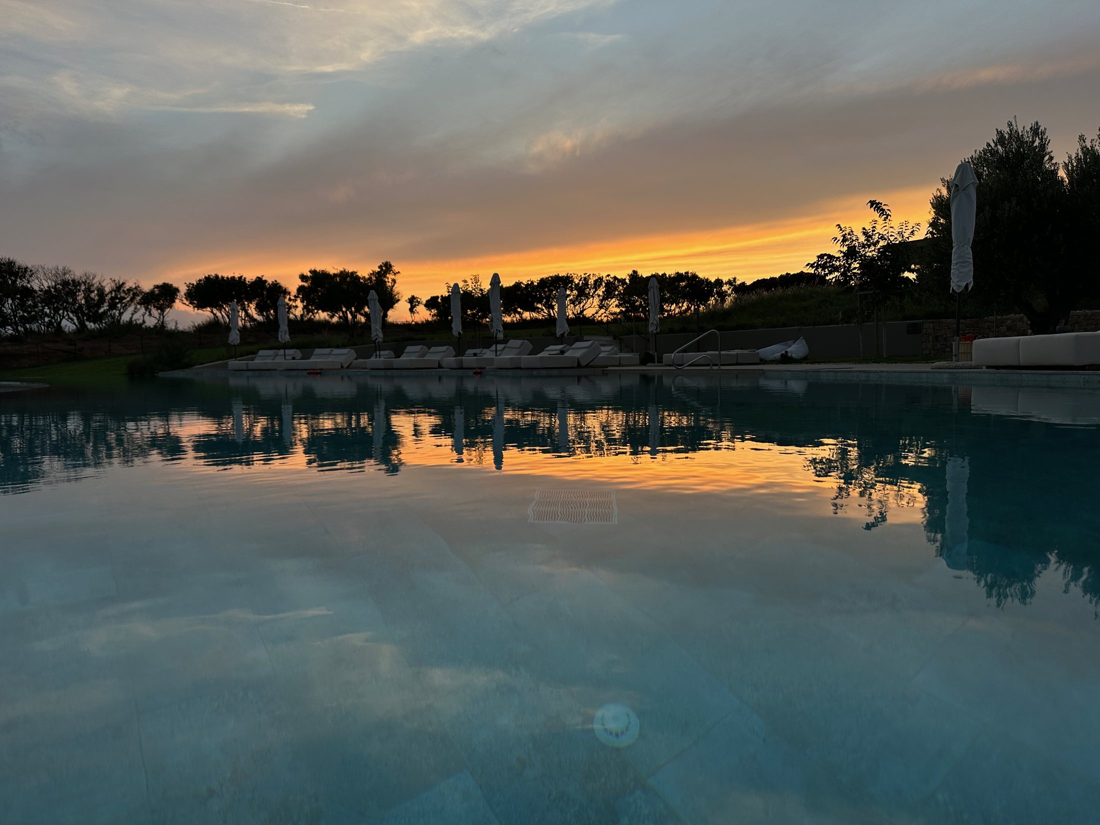 Pool at sunset with reflections at Zelia Halkidiki