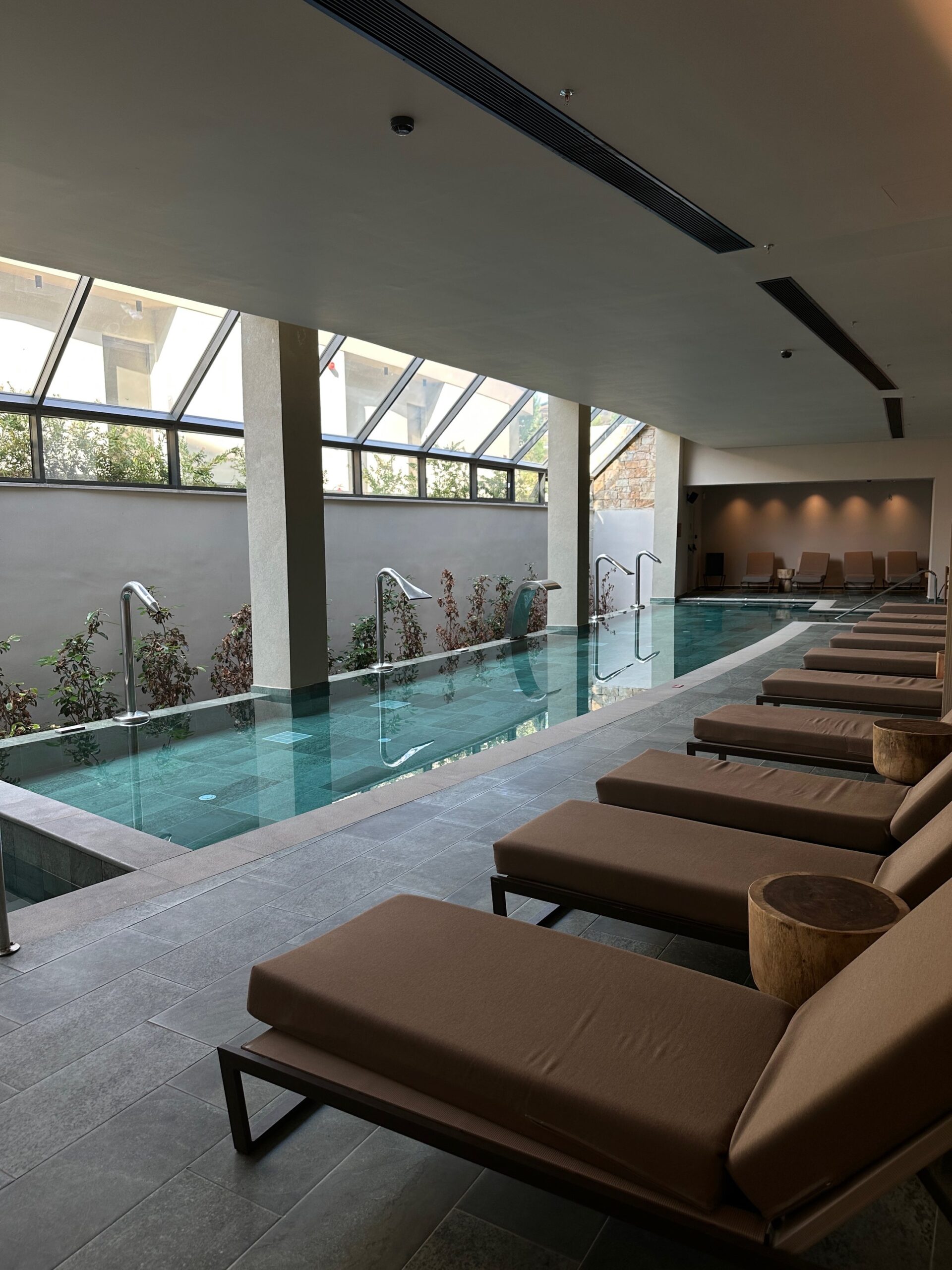 Indoor spa pool with loungers at Zelia Halkidiki